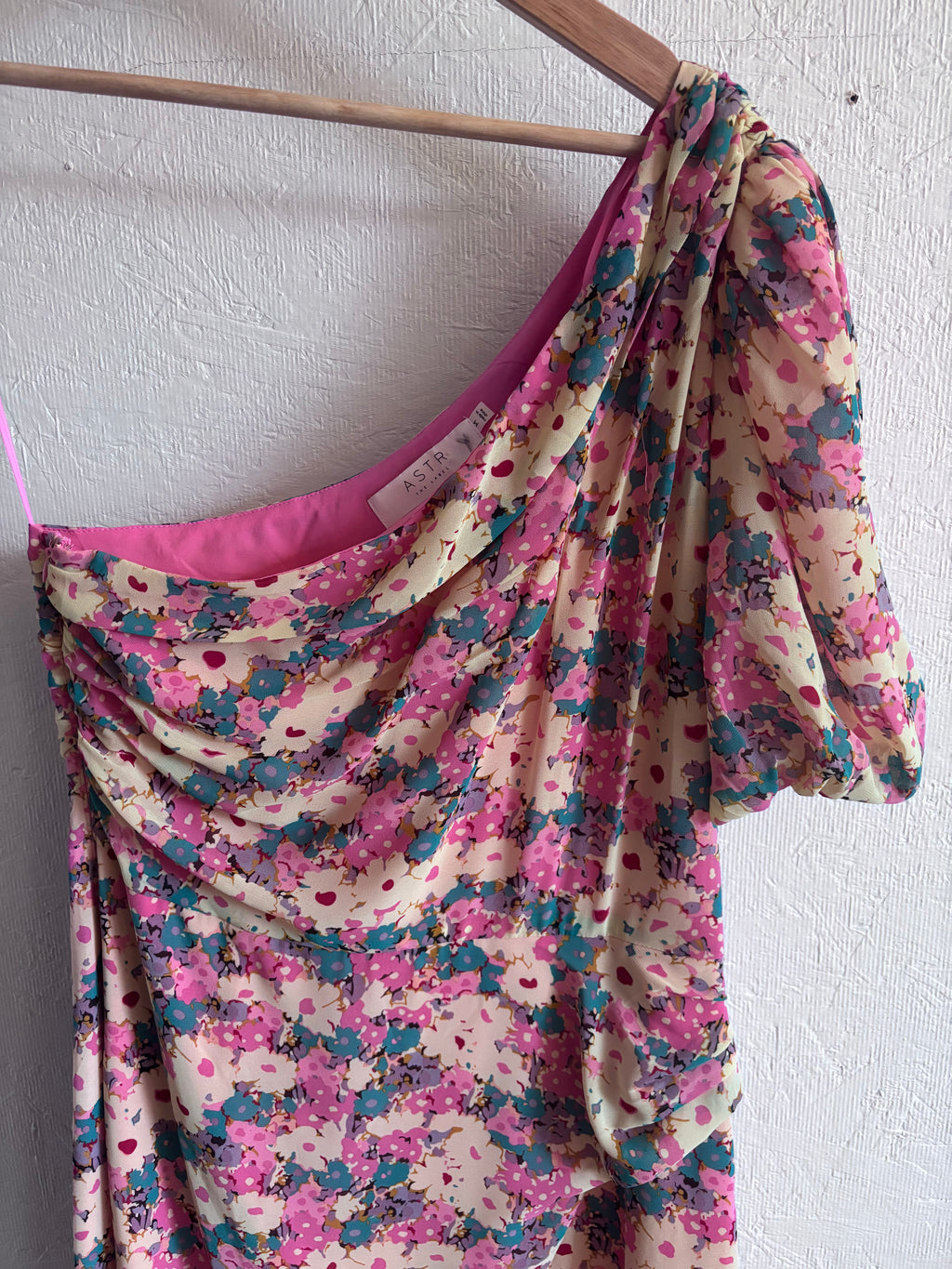 Revolve’s ASTR The Label Pink Floral One Puff Sleeve Asymmetrical Midi Dress