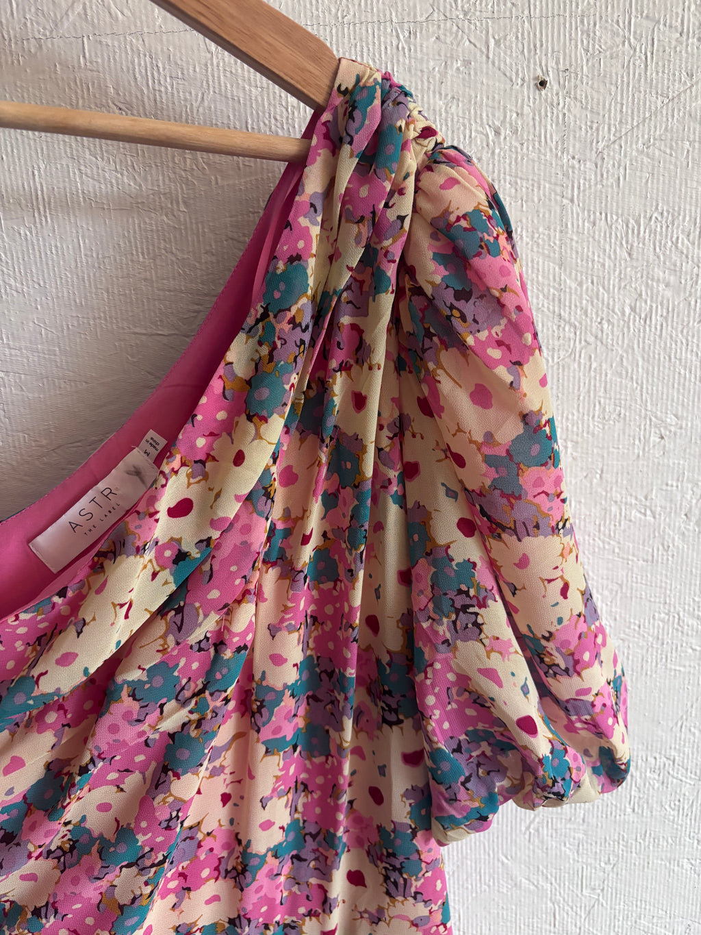 Revolve’s ASTR The Label Pink Floral One Puff Sleeve Asymmetrical Midi Dress